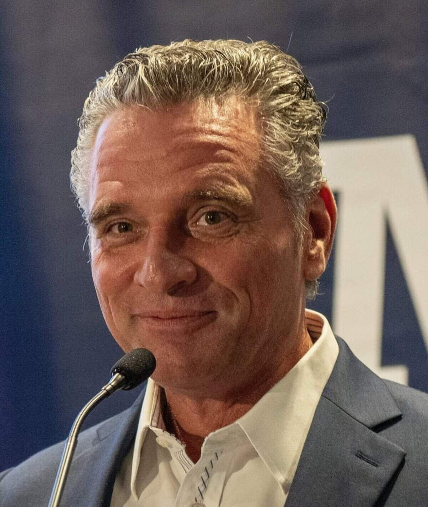 Ty Masterson speaks to the crowd after being declared the winner in the Republican primary for Kansas governor. At left is US Congressman Roger Marshall.