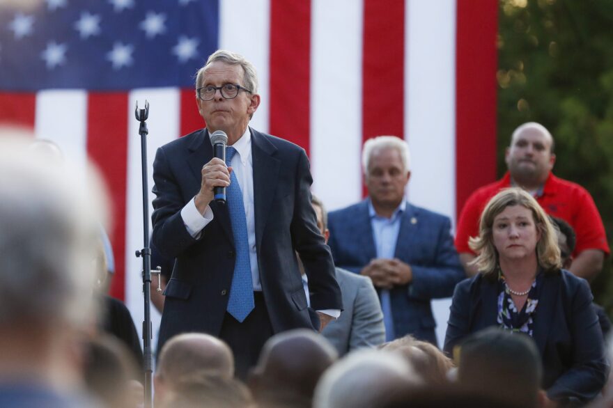 Ohio Gov. Mike DeWine, left, speaks alongside Dayton Mayor Nan Whaley, right, during a vigil at the scene of a mass shooting, Aug. 4, 2019, in Dayton, Ohio. (John Minchillo/AP)