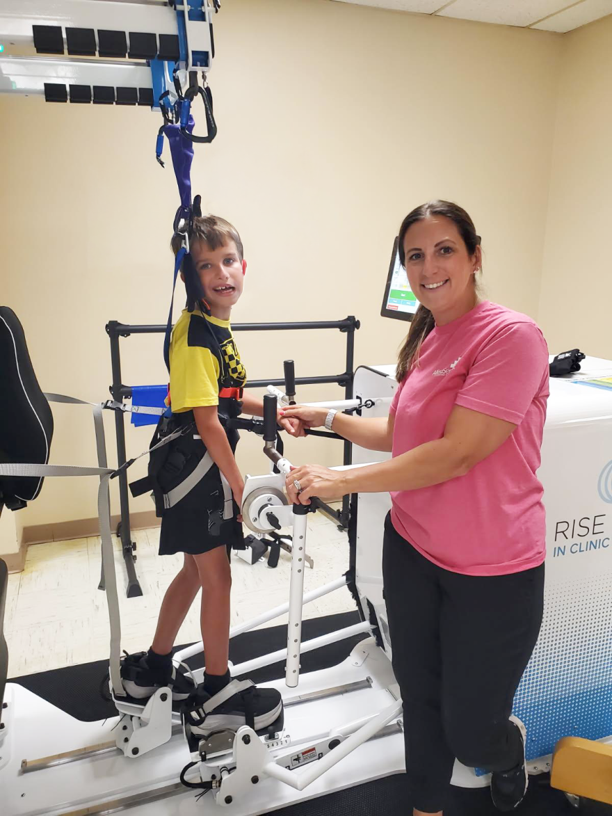 Pediatric therapist Sarah Prebich helps her patient Liam in the Rise&Walk.