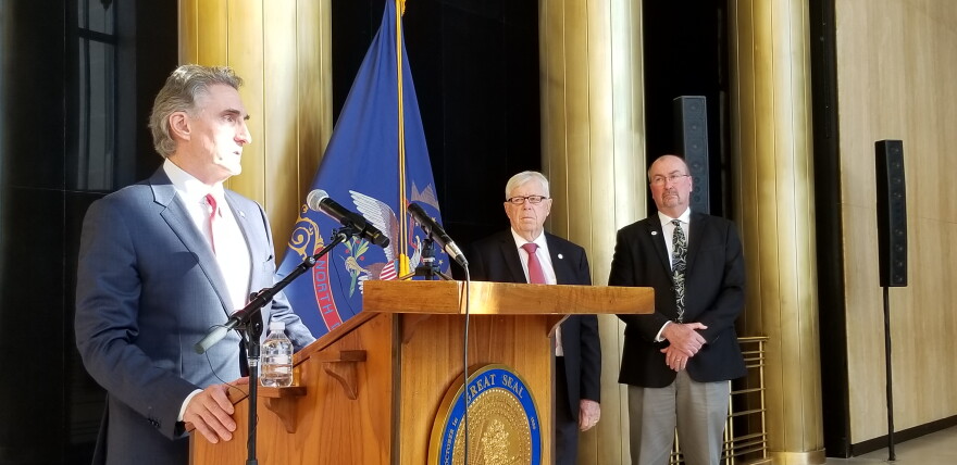 Gov. Doug Burgum (at lectern), Senate Majority Leader Rich Wardner and House Majority Leader Chet Pollert at a Capitol news conference
