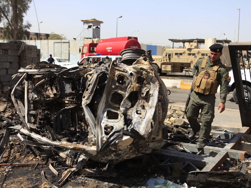 An Iraqi soldier stands at the scene of a car bomb attack on the Justice Ministry a day earlier, in Baghdad on Friday.