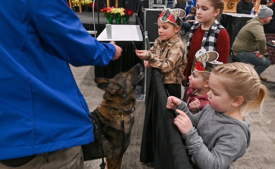 Children meet Lucky the dog, the first dog trained to detect the Spotted Lantern Fly.
