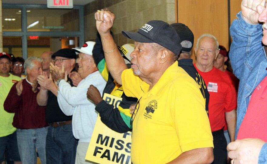 Lew Moye, president emeritus of the Coalition for Black Trade Unionists, raises his fist Saturday, Sept 12, 2015 at a union rally against right to work in Arnold, Mo.