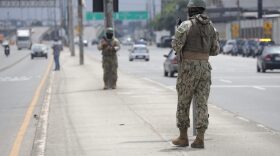 A military officer stands guard in a street in Guayaquil, Ecuador.