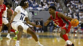 New Mexico guard Jamal Mashburn Jr. (5) drives past Nevada forward Tre Coleman (14) during the first half of an NCAA college basketball game in Reno, Nev., Monday, Jan. 23, 2023. (AP Photo/Tom R. Smedes)
