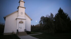 The moon rises behind Zion Church, built in 1881, at the Madison County Historical Society on October 29, 2020 in Winterset, Iowa. (Mario Tama/Getty Images)