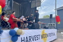 Performers in traditional Chinese dress and playing various traditional instruments sit on stage during the 2024 Harvest Moon Festival at Schoen Place in Pittsford.