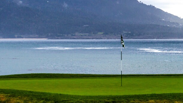 The 18th green at Pebble Beach golf course, with Carmel Bay and Point Pinos in the background.