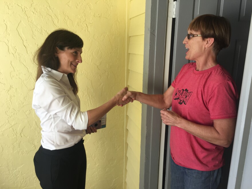 Margaret Good (left), Democratic candidate for a state House seat in Florida, campaigns for votes in Sarasota, Fla., on Monday. Good beat Republican James Buchanan by 7 percentage points in a district that President Trump won two years ago by a 5-point margin.