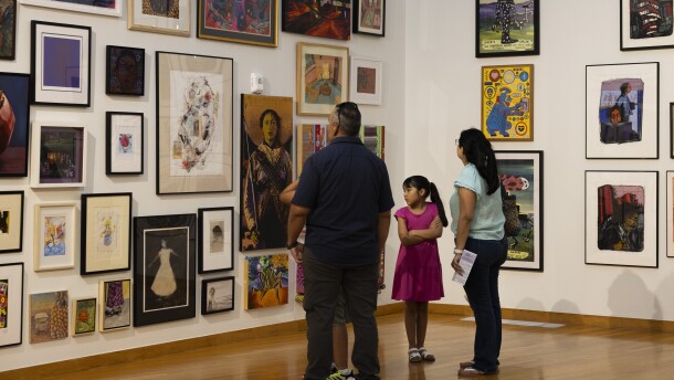 People look at art in a gallery .