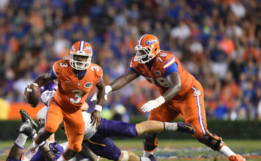 Florida quarterback Treon Harris (3) scrambles to gain yards.