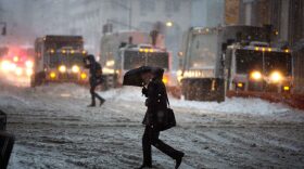 Snow plows line up on Fifth Avenue during a day of heavy snow and freezing rain on March 14, 2017, in New York. (Kevin Hagen/Getty Images)