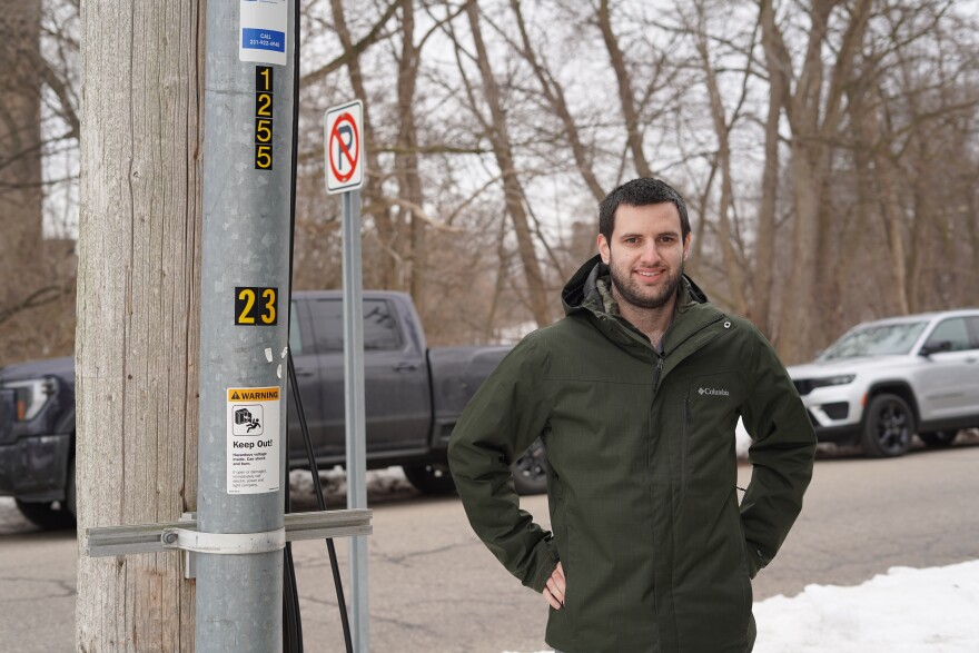 Tony Chartrand, director of electric engineering and operations for Traverse City Light & Power, stands next to a conduit that contains an underground wire. (Photo: Vivian La/IPR News)