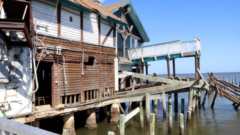 A damaged building sits along the waterfront in Cedar Key, Fla. The structure shows lingering impacts along the shoreline nearly two years after Hurricane Helene.