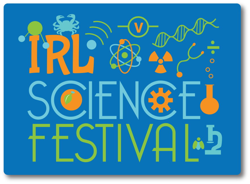 Logo for the IRL Science Festival: bold orange “IRL” above “SCIENCE” in light blue and “FESTIVAL” in green, on a blue rounded rectangle surrounded by science icons.