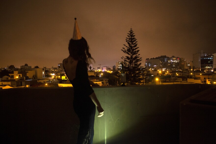 Macarena Tabja del Solar commemorated her 40th birthday with a self-portrait. COVID-19 has made a milestone celebration with friends impossible, and Lima has a 10 p.m. curfew, she says. "So instead, I bought one birthday hat, put on a nice dress and went to my rooftop with some wine and my camera." <em>July 8. Lima, Peru. </em>