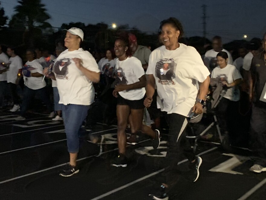 Evelyn Brady (right) leads a run to honor her son, Mohammed Haitham, who was killed in a mass shooting at the Pensacola Naval Base. Kerry Sheridan/WUSF 