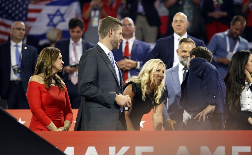 Vice Presidential pick JD Vance, right, talks with Rep. Marjorie Taylor Greene, center, during the session at the Fiserv Forum for the Republican National Convention in Milwaukee, Wis., Tuesday, July 17, 2024. (Ashleigh Lucas/WUFT News)