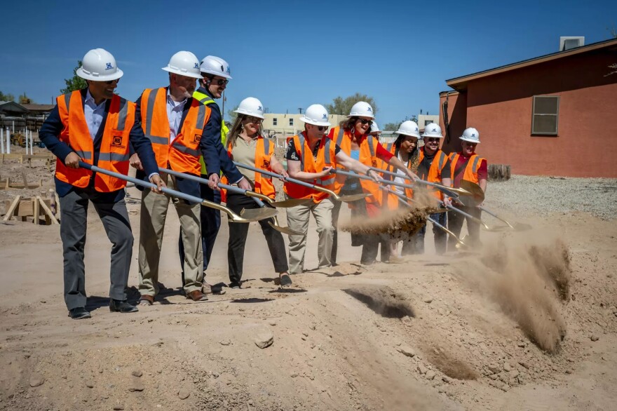 Local leaders shovel dirt during the official groundbreaking for the Casitas del Camino affordable housing project in Northwest Albuquerque