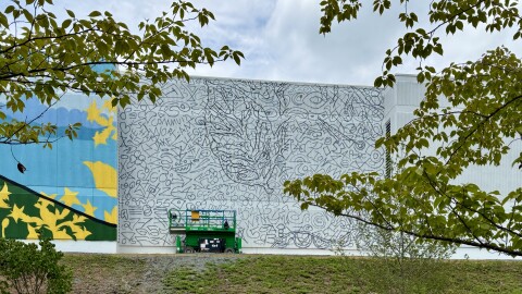 A half painted mural featuring a doodle grid