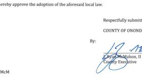 A portion of the document signed by County Executive Ryan McMahon in error, approving a term limits law he intended to veto.