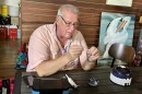 A man inserts a testing strip into a shrimp
