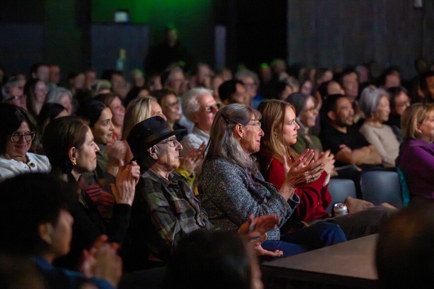 Audience members listen to live storytelling at the 9th annual Immigrant Voices storytelling event. March 12, 2026.