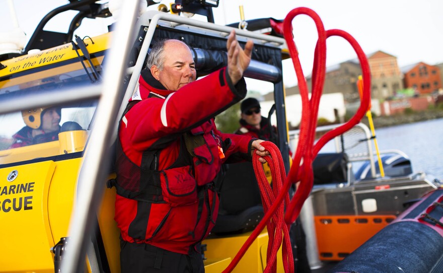 Alan Lawrence throws out a line to a "broken down vessel" during a Royal Canadian Marine Search and Rescue Station 35 training exercise in Victoria Harbour.