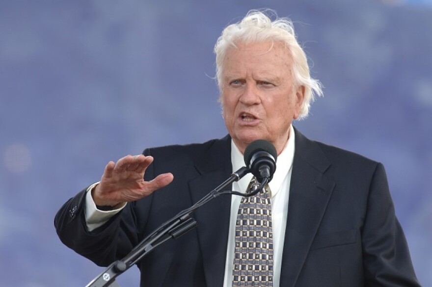 photo of Billy Graham speaking a microphone