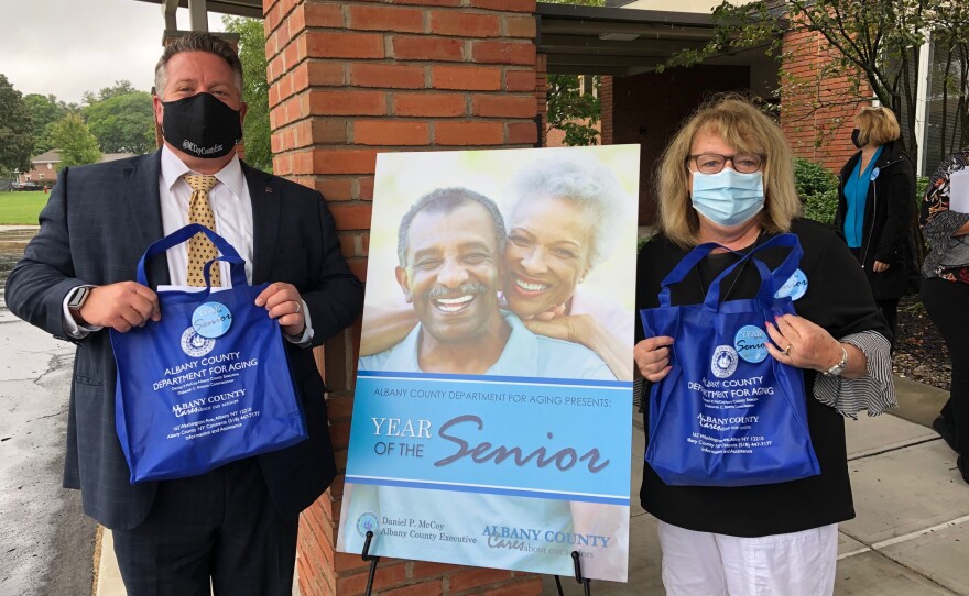 County Executive Dan McCoy and County Department for Aging Commissioner Deb   Riitano handed out "flu prevention bags" to seniors at a drive-through event in   Congregation Beth Emeth's parking lot.