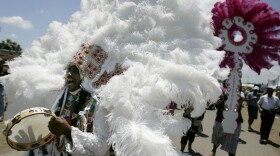 Mardi Gras Indians march through the crowd at the 2007 New Orleans Jazz and Heritage Festival. The Mardi Gras Indians are a mainstay of New Orleans culture, marching alongside brass bands in the annual Mardi Gras parades.