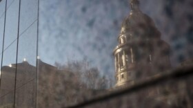 The Texas Capitol is seen reflected on a building.