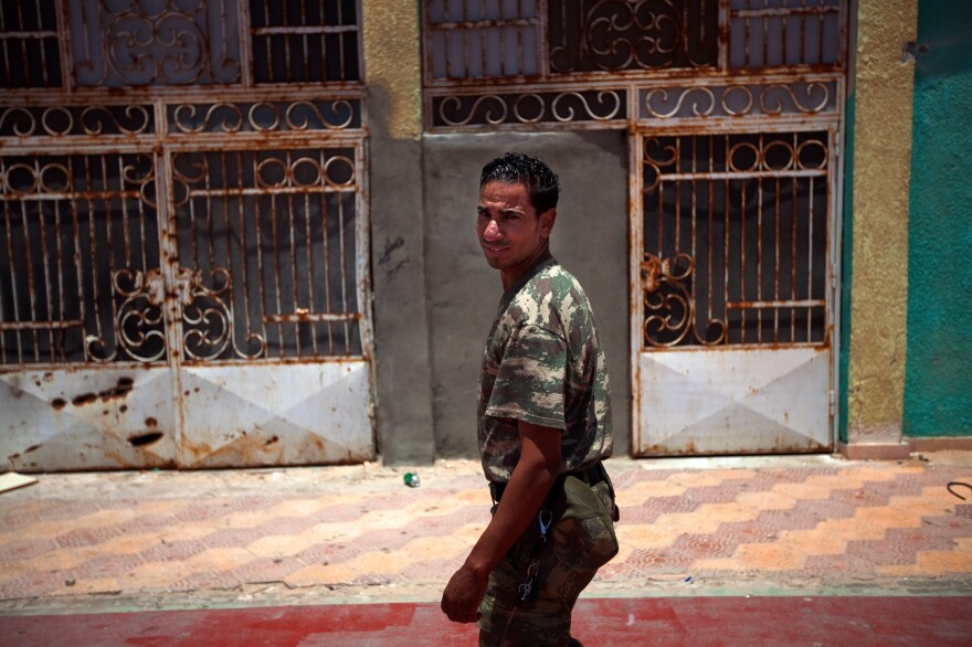 The vice principal at the Okba Bennafee high school, Abdel Mutaleb Suker, is a former rebel who says he started wearing military fatigues to command respect from the students, many of whom come from families loyal to Gadhafi.