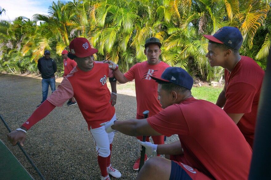 Nationals outfielder Victor Robles (left) talks with prospects Adderlng Ruiz (left to right), Luis Villorio and Soto at the team's Dominican Republic training camp in Boca Chica in January 2018. Soto was called up to the majors four months later.