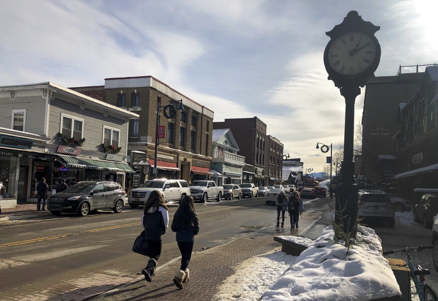 Pedestrians walk down Main Street, Friday, Jan. 31, 2020 in Lake Placid, N.Y. The surge in the number of short-term rentals in this Adirondack Mountain resort is alarming local residents who fear it is changing the character of the village.