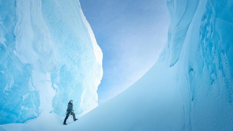 Ages of Ice man walks in ice crevice