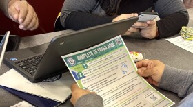 A family works on completing the FAFSA form at Lawrence Central High School on Wednesday, April 3, 2024.