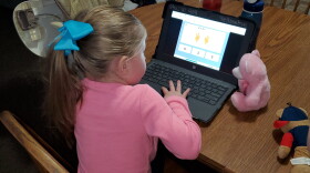 Amie Payne's six-year-old daughter, a kindergartner at Findley Elementary, surrounds herself with some of her favorite fluffy friends as she learns remotely at home.