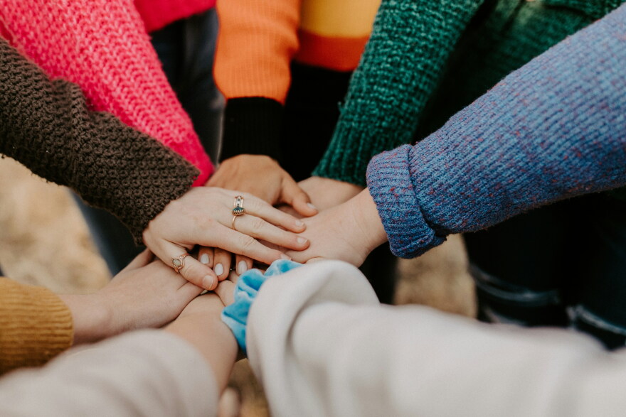 A group of hands stacked on top of each other.