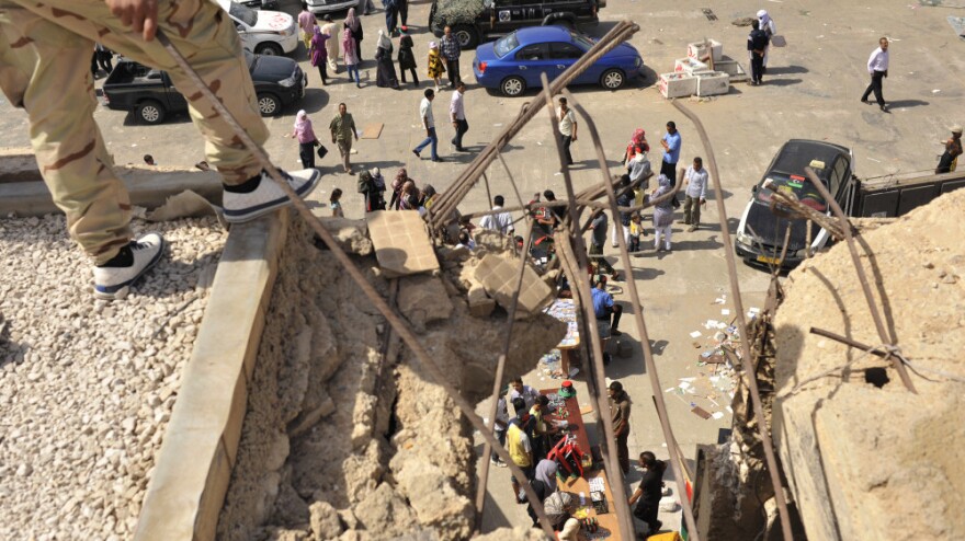 <p>Libyans visit the destroyed Bab al-Azizia military barracks and compound of their country's ousted leader Moammar Gadhafi, in the southern suburbs of Tripoli, Libya.</p>