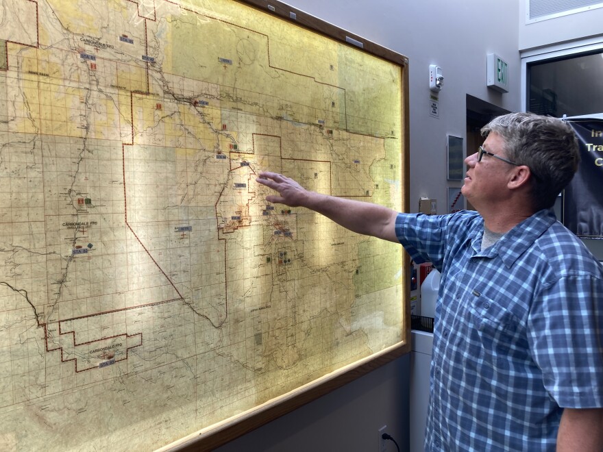 Brett Loeb points to a map of the Roaring Fork Valley and the different fire and dispatch districts at the Pitkin County Regional Emergency Dispatch Center on July 8. Loeb wants to send all Pitkin Alerts in Spanish by the start of the winter season.
