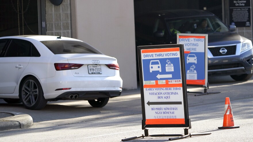 Cars enter and leave a drive-thru voting site in Houston on Election Day in 2020. Texas Republican lawmakers are looking to ban the practice.