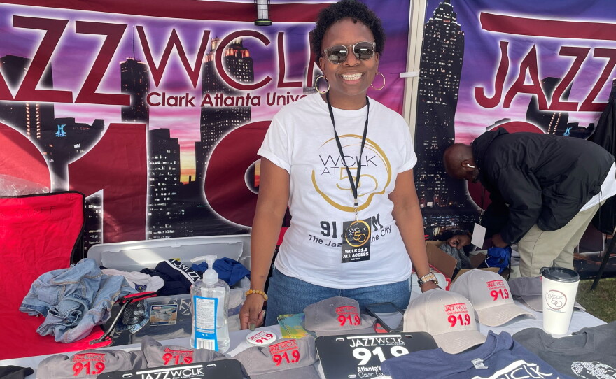 WCLK's Membership Manager Joi John selling WCLK Paraphernalia at The Ville.