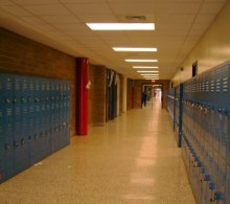 An image of an empty hallway in Pender High School. It's line with blue lockers. 