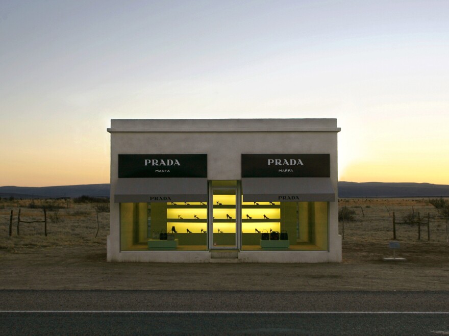 <em>Prada, Marfa</em> is a faux boutique displaying luxury bags and shoes in the middle of the sparse Texas landscape. It was created in 2005 by artist duo Michael Elmgreen and Ingar Dragset.