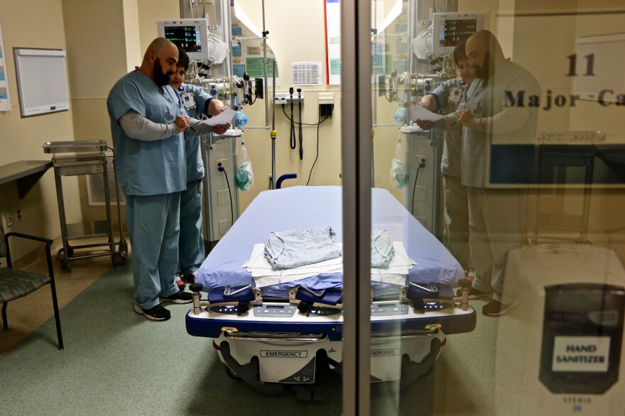 A doctor and nurse confer inside a room used for flu patients at Northside Hospital in Cumming, Georgia. 