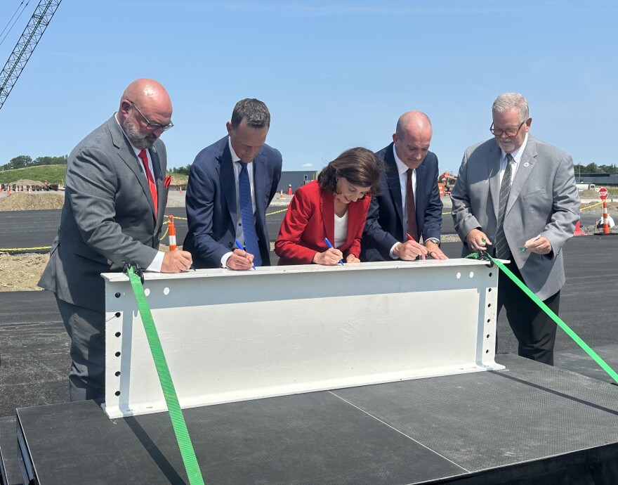 Governor Kathy Hochul and healthcare leaders signing a beam of the new hospital set to open in 2029.