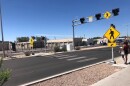 A person in Albuquerque, N.M., approaches a recently installed crosswalk with warning lights for safety in 2024. New Mexico’s pedestrian fatalities dropped by almost half in early 2025 compared to the same period during the previous year.