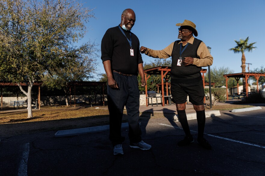 Roommates Ricky Jones, 69, (right) and Richard Crumbley, 63, make jokes after a roll call early morning at Grand Veterans Village in Phoenix.