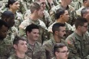 Indiana National Guard members listen as Gov. Eric Holcomb speaks at a departure ceremony on Thursday, March 28, 2024. Soldiers soon leave for Texas.